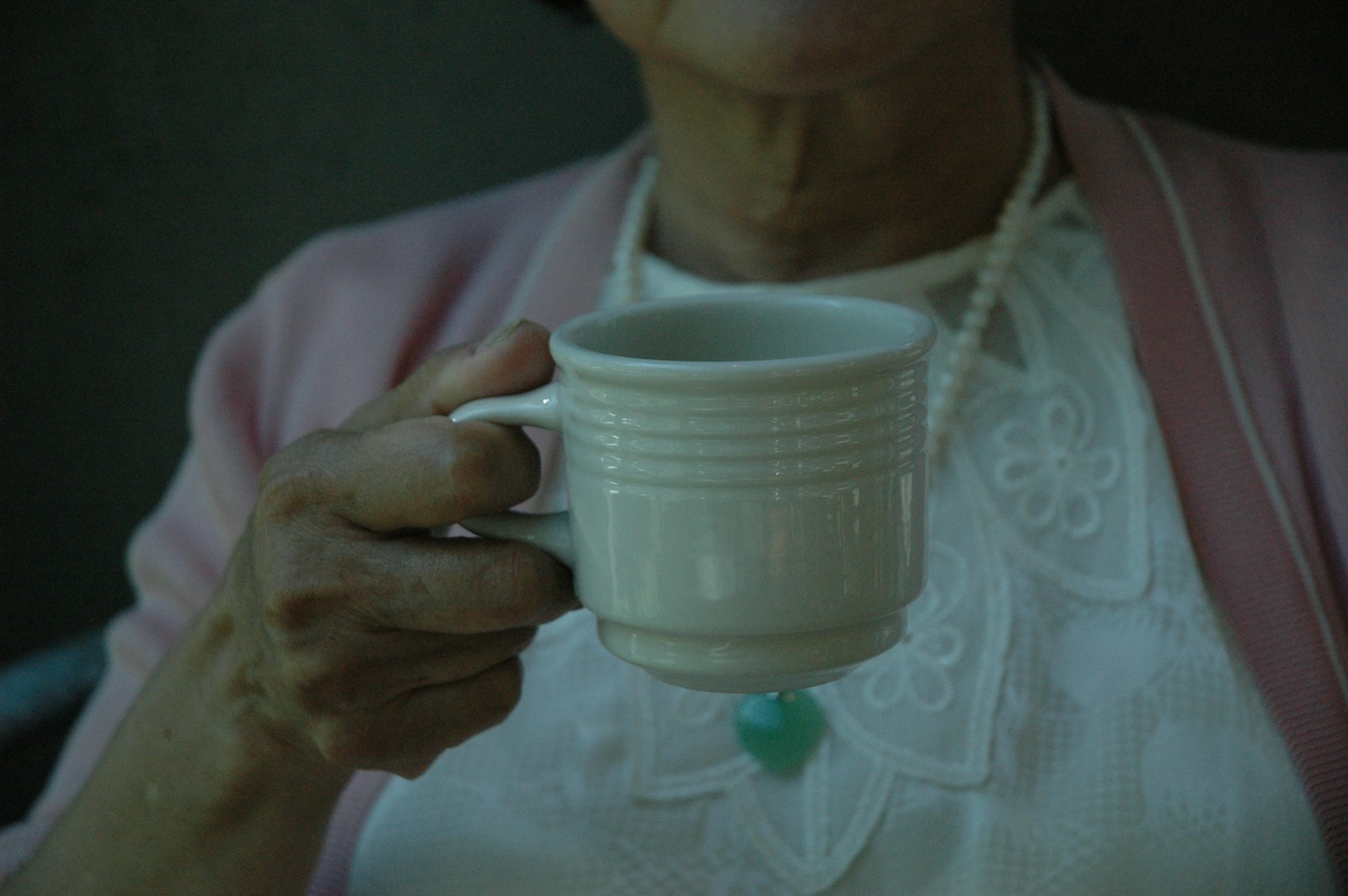 woman holding white cup